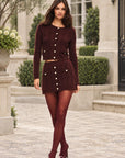 LoveShackFancy Berritt Skirt in cinnabar, on model in a townhouse courtyard